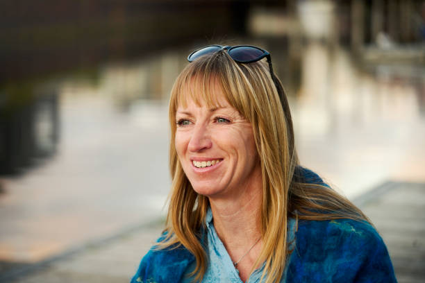 istock Woman sitting at waterfront 1692237284