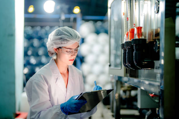istock scientist worker checking the quality of Reverse osmosis machine system at the industrial factory. Female worker recording data at the control panel with measure pressure for recycle portable plant. 1692248033