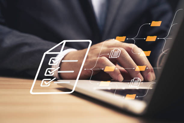 istock Businessman using laptop computer and touching to online electronic paper for approve ISO quality document control certification and project approval concept. 1692250320
