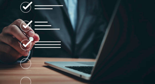 istock Businessman using laptop computer and touching to online electronic paper for approve ISO quality document control certification and project approval concept. 1692250925