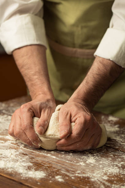 istock kneading bread dough on wooden desk 1692262493