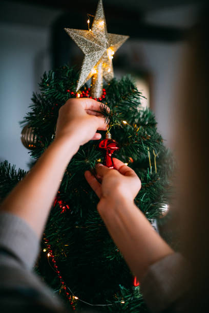 istock Woman Decorates the Christmas Tree 1692264226