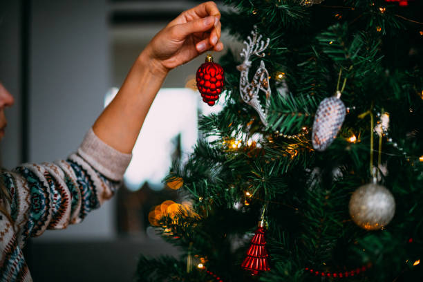 istock Young Woman Decorates the Christmas Tree 1692264793
