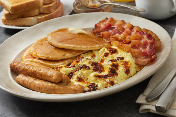 istock Spicy Chili Crisp Breakfast with Scambled eggs, Pancakes, Bacon, Sausages and Toast 1692266607