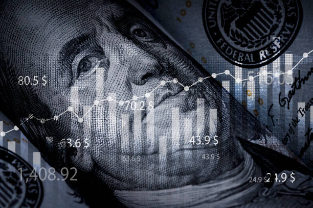 istock Closeup Benjamin Franklin face on USD banknote with stock market chart graph for currency exchange and global trade forex concept. 1692270634