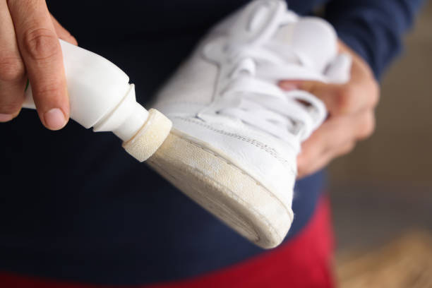 Woman cleaning white shoes Woman cleaning white shoes shoe polish photos stock pictures, royalty-free photos & images