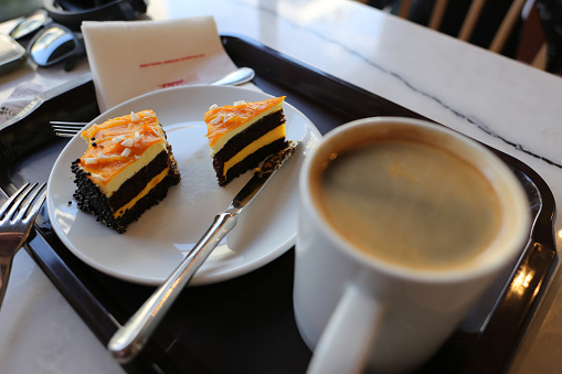 Close up photo of a cup of coffee and pumpkin cake