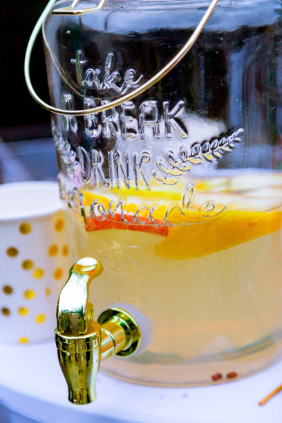 Glass juice fountain with orange juice