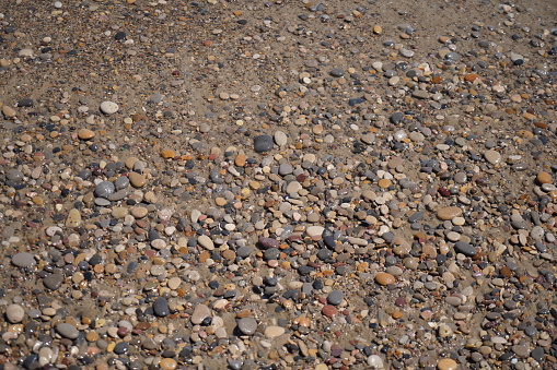 pebbles on sea beach washed round and flat