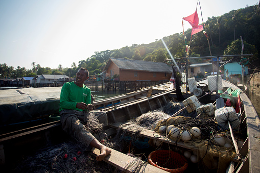 Koh Yao, Thailand; 1st January 2023: Fisherman in Koh Yao fishing village preparing nets to catch fish..