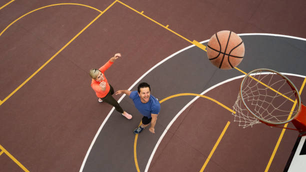 istock High Angle view Couple casually playing basketball shooting hoops 1692318363