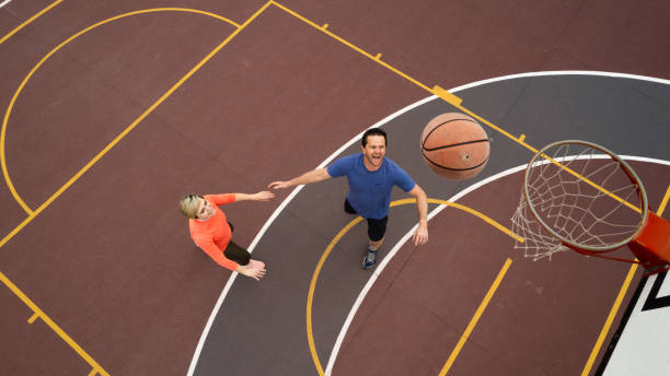 istock High Angle view Couple casually playing basketball having fun on court 1692318439