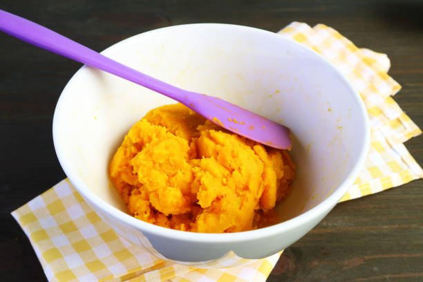 Pumpkin Puree in a Mixing Bow for Baking Pumpkin Pie Pumpkin Puree in a Mixing Bow for Baking Pumpkin Pie kabocha stock pictures, royalty-free photos & images