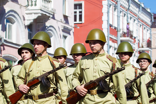 May 09, 2022 Belarus, Gomel region. Holiday of Victory. Build soldiers with guns in WWII clothes.