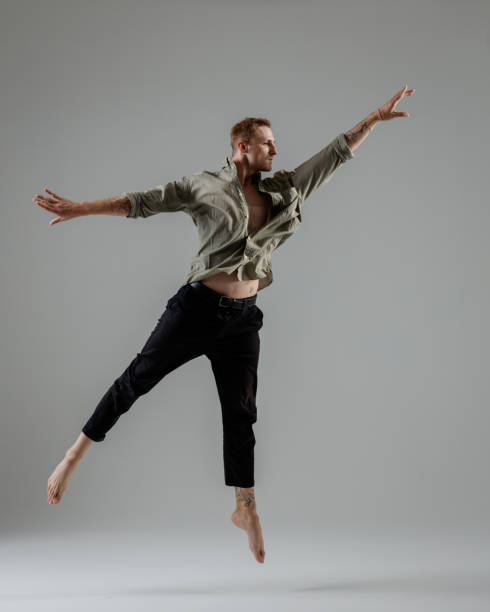 istock Modern Male Dancer on gray background 1692340642