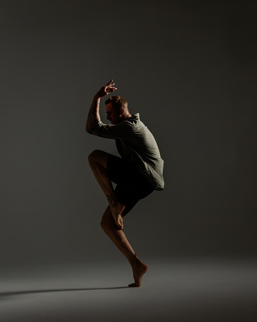 Modern Male Dancer on dark gray background