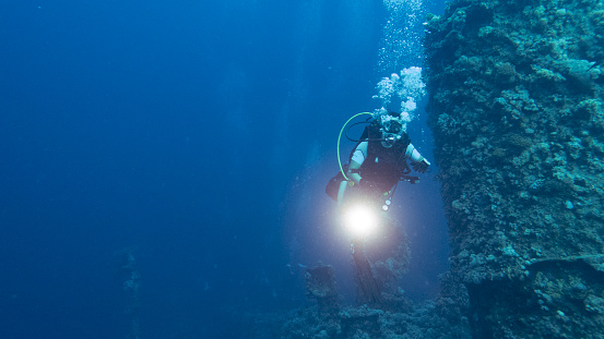 Female scuba diver on the wreck of the Iona ship in the red sea offshore from Yanbu, Saudi Arabia