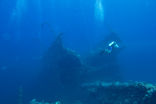 Scuba diver on the wreck of the Iona ship in the red sea offshore from Yanbu, Saudi Arabia
