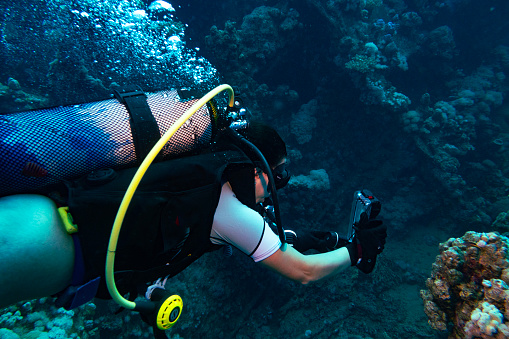 Female scuba diver on the wreck of the Iona ship in the red sea offshore from Yanbu, Saudi Arabia