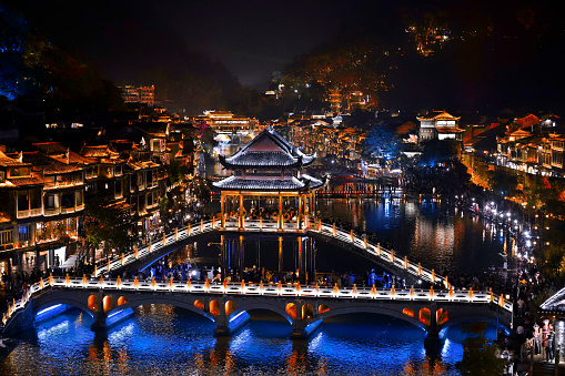 This was taken in Fenghuang County or Phoenix Ancient Town, Hunan province, which is reputed as “the most beautiful town in China” and “Town in a Picture”. It was built in 1704 and gathering place for Miao, Tujia and other 26 minority ethnic groups. During the day, the town is quiet, when the lights are on at night, the town becomes lively. If you enjoy boating at night, you can appreciate the strings of various red lanterns outside the antique windows reflecting on the clear river. At night, when the lights are all shining along the river, you can appreciate the amazingly charming night view, with the water flowing gently, cool wind blowing away, musical sound floating by, and the reflection of lights dyeing the river into a wonderful world.