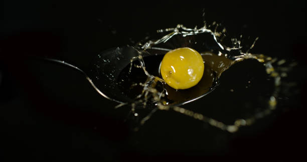 istock Green Olive, Olea europaea, Falling on Olive Oil against Black Background 1692364279