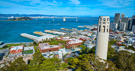 Image of Aerial beside Coit Tower on Telegraph Hill with view of city with boats and Oakland Bay Bridge