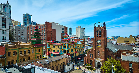 Image of Aerial of colorful Chinatown buildings and church on blue sky day with partial clouds