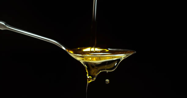 istock Olive Oil, Falling in a Spoon against Black Background 1692372074