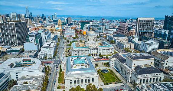 Image of Aerial view of city and city hall with memorial court and distant San Francisco Bay