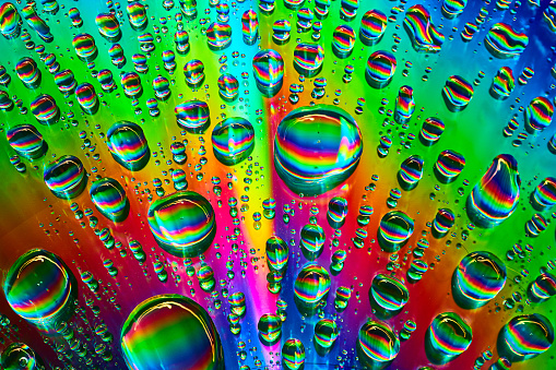 Image of Brilliant burst of rainbow colors in water drops in abstract background asset