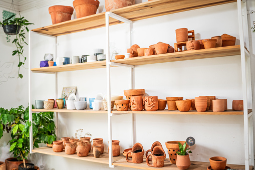 Terracotta clay pots for garden plants and flowers. Decorative flower pots and vases outside. Flower business