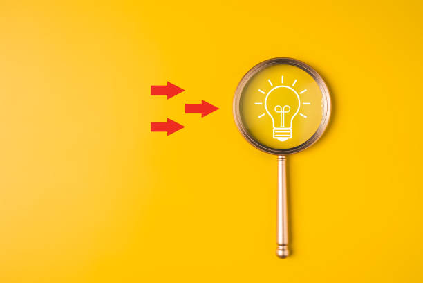 istock Magnifying glass with light bulb for business strategy planning management, Business process and workflow development, Survey and quality control assessment to achieve business goal 1692388950