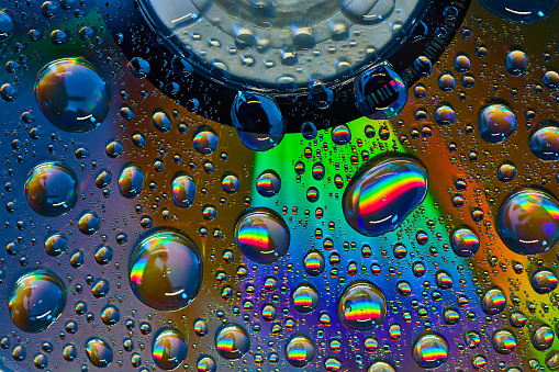 Image of Thick blue and green beam of light behind floating bubbles in abstract background asset