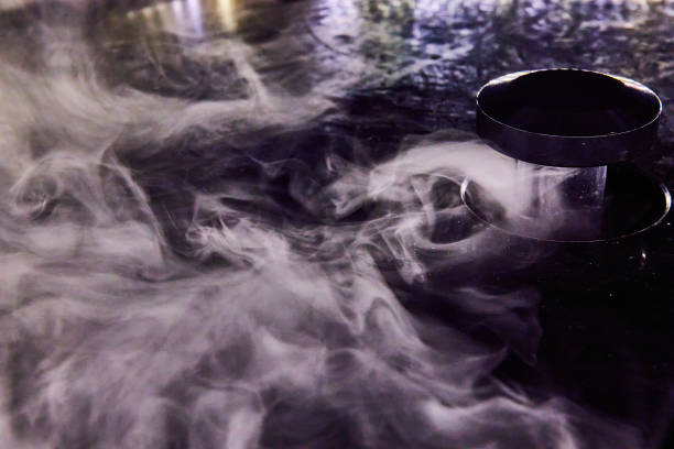 istock White misty fog swirling around with cloud maker in black container 1692403297