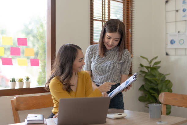 istock Two Young Asian businesswoman discuss with new startup project Idea presentation, analyze planning and financial statistics and investment market at office. 1692403428