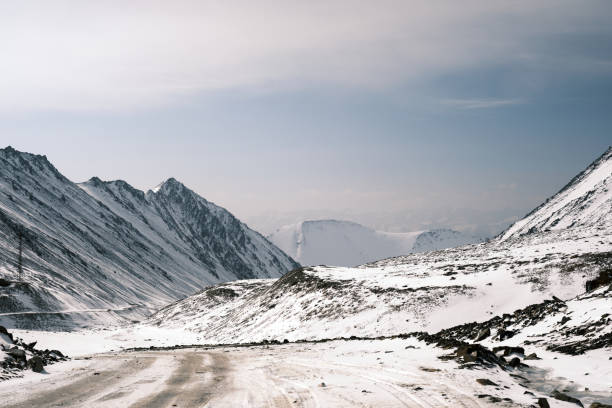 istock Snowy road on mountain pass in autumn 1692411577