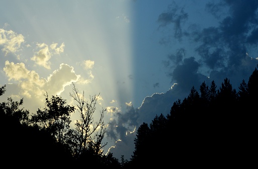 Empty Blue sky with gorgeous clouds and sun shining through