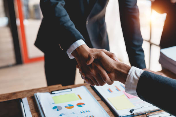 Business people shaking hands during a meeting.