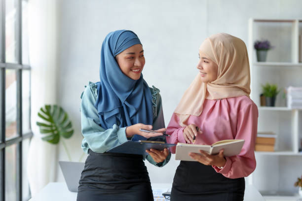 istock Team work process Two Muslim business women pointing at a laptop computer and discussing document and ideas at a meeting. 1692419183