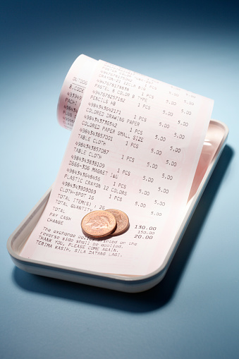 Receipt, coin and tray isolated on blue background.