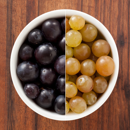 Composition of two shots of small grapes varieties for contrast concept
