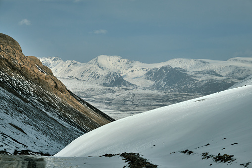 Snowcapped peaks view from mountain pass