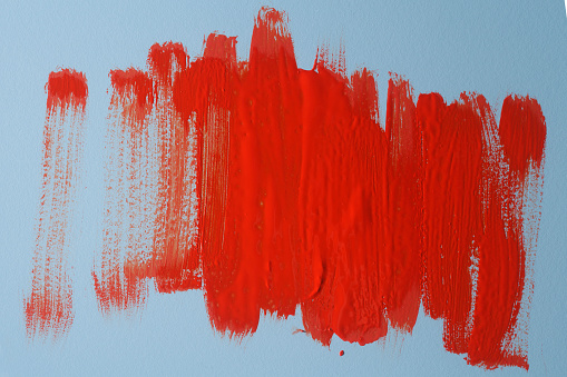 Abstract red real oil painting brush strokes isolated on blue background.