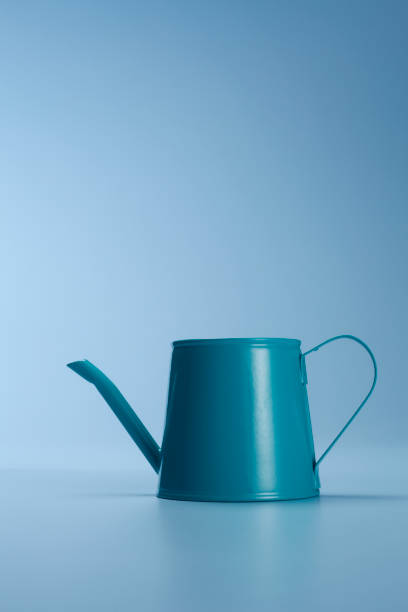 istock Watering can isolated on the blue background. 1692440761