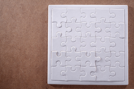 Completed jigsaw puzzle isolated on a wooden table.