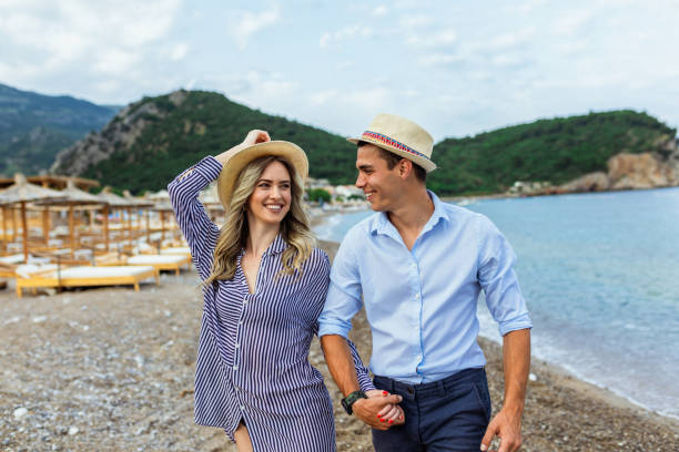 istock Happy young couple laughing and hugging on the beach 1692455497