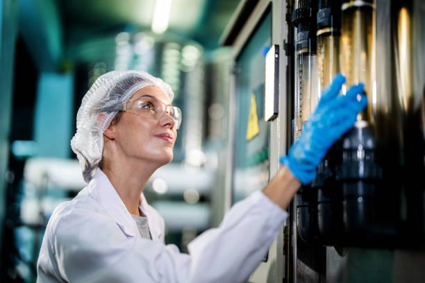 istock scientist woman worker checking and monitoring the control panel on machine system at the industrial factory. Female worker recording data at the control panel with measure pressure of water level. 1692461031