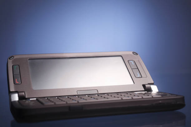 istock old discontinued cell phone handsets on a blue background. 1692467981