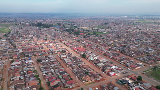Thembisa township in South Africa. Wide aerial of low income houses and dusty streets.