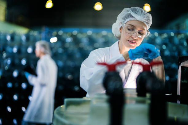 istock scientist worker checking the quality of Reverse osmosis machine system at the industrial factory. Female worker recording data at the control panel with measure pressure for recycle portable plant. 1692470927